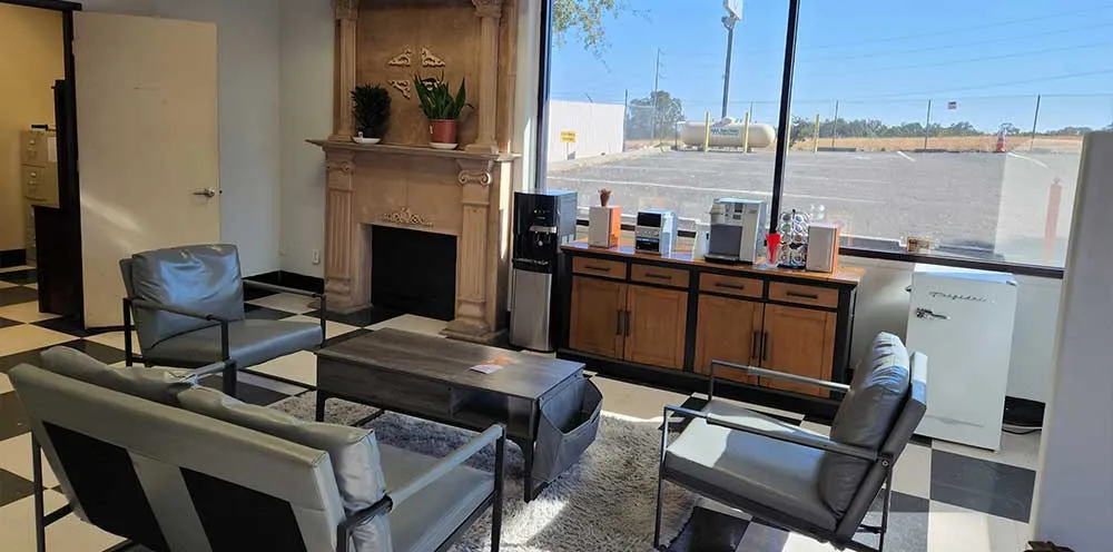 Cozy office waiting area with seating and fireplace.