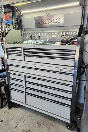 Large Husky tool chest with multiple drawers in garage.