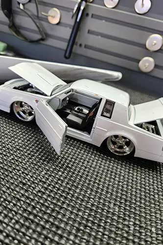 White model car with open doors and hood